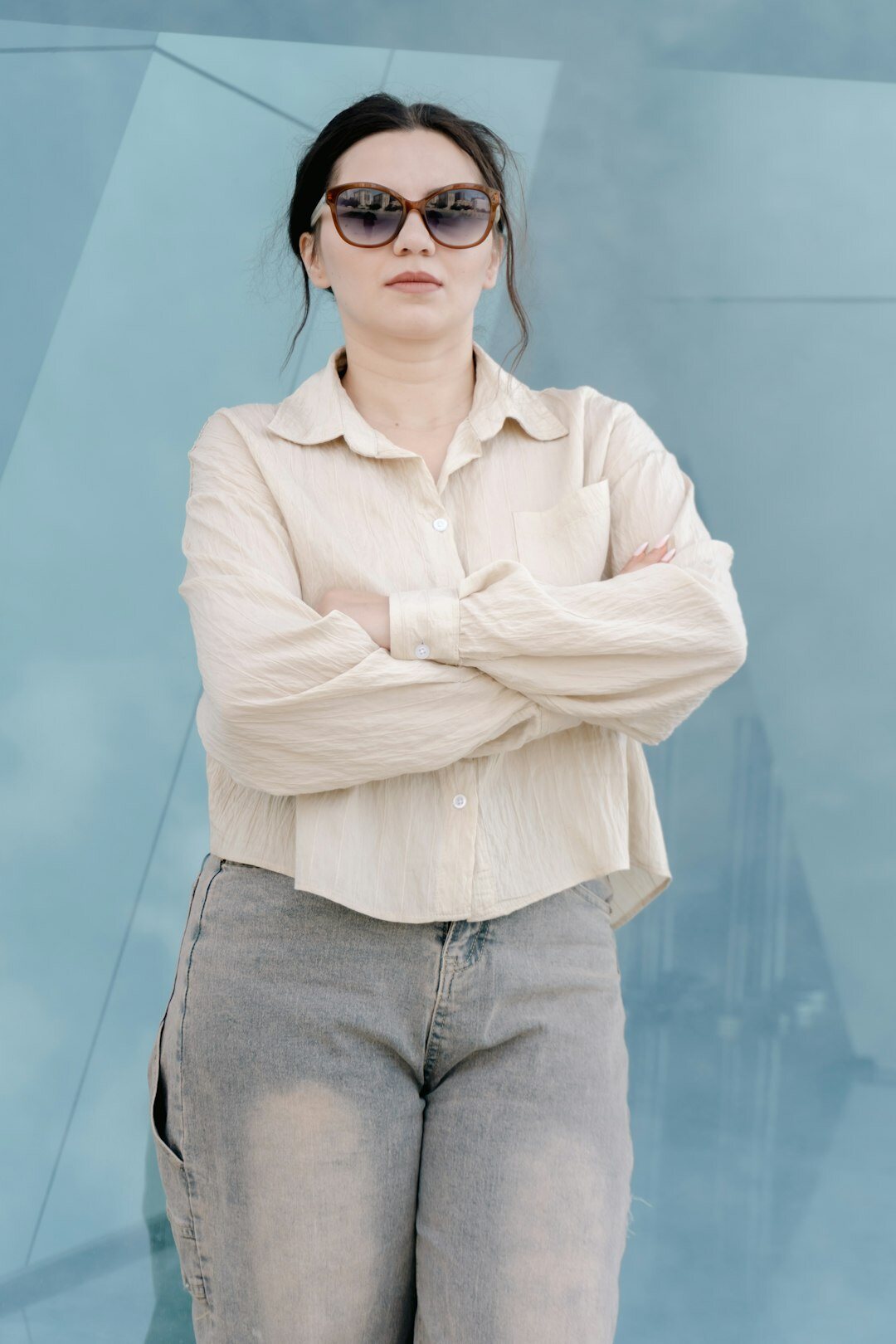 Belgian woman standing with arms crossed showing calm confidence