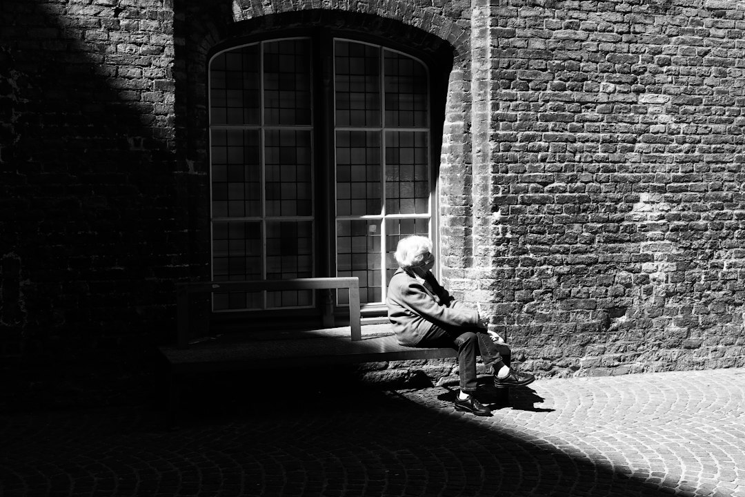 Belgian man in thoughtful pose looking out of a window